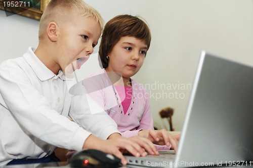 Image of childrens have fun and playing games on laptop computer