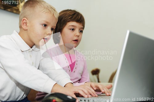 Image of childrens have fun and playing games on laptop computer