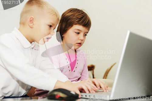 Image of childrens have fun and playing games on laptop computer