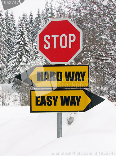 Image of hard and easy way road sign in nature