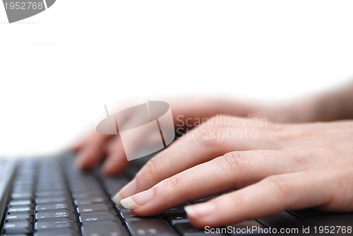 Image of Isolated female hand typing on laptop keyboard