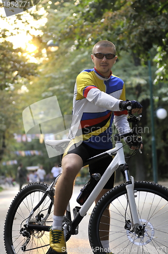 Image of Fit happy young man smiling on bike
