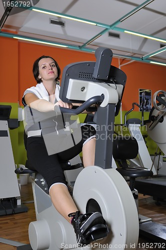 Image of Young woman working out in gym