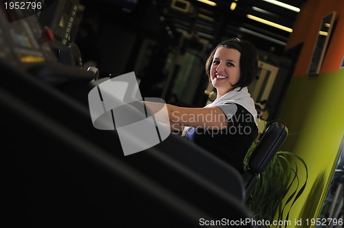 Image of Young woman working out in gym