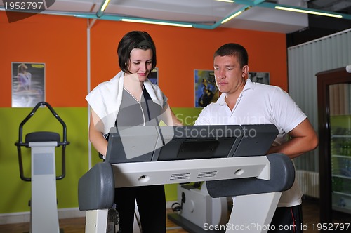 Image of Young woman  working out with coach