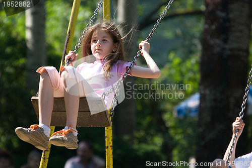 Image of happy girl swinging 