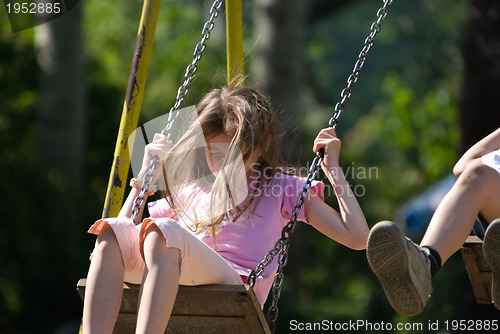 Image of happy girl swinging 