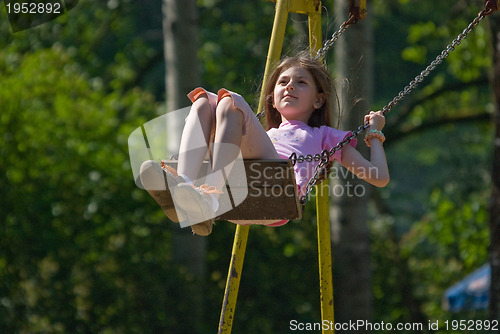 Image of happy girl swinging 