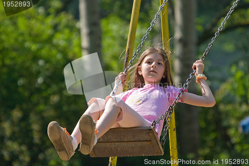 Image of happy girl swinging 