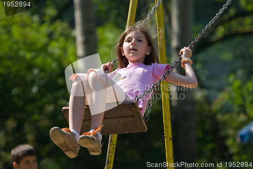 Image of happy girl swinging 