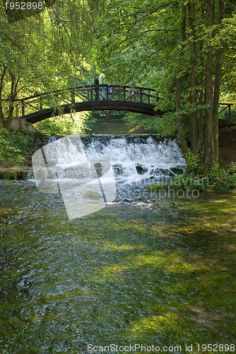 Image of wooden bring over small waterfall 