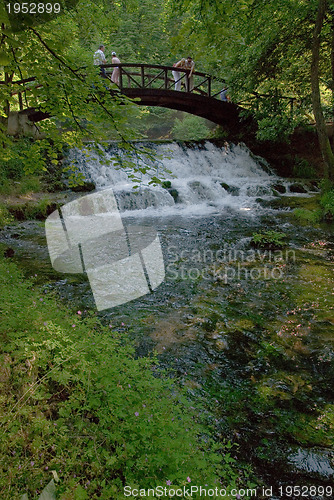 Image of wooden bring over small waterfall 