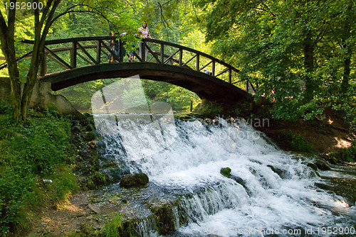 Image of wooden bring over small waterfall 