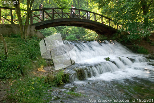 Image of wooden bring over small waterfall 