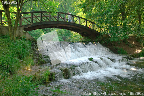 Image of wooden bring over small waterfall 