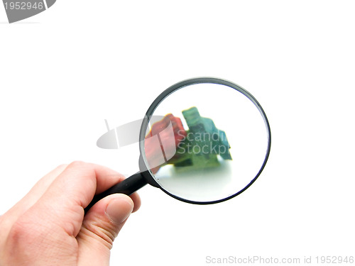Image of hand with magnifying glass