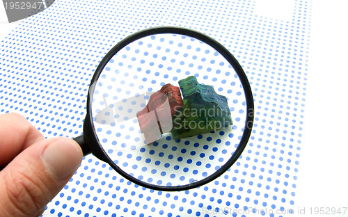 Image of hand with magnifying glass