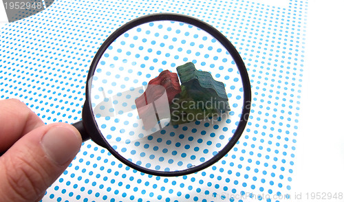 Image of hand with magnifying glass