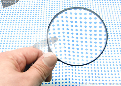 Image of hand with magnifying glass