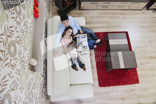 Image of happy family looking photos at home