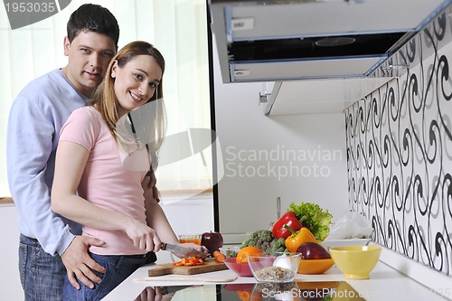 Image of couple have fun and preparing healthy food in kitchen