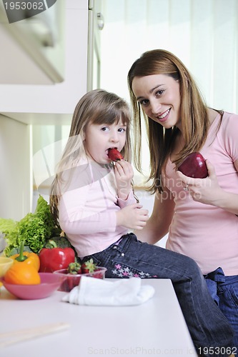 Image of happy daughter and mom in kitchen