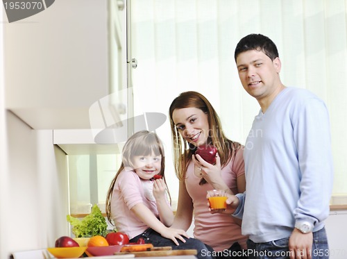 Image of happy young family in kitchen