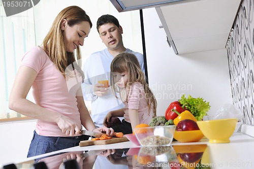 Image of happy young family in kitchen
