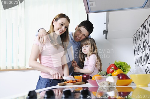 Image of happy young family in kitchen