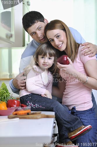 Image of happy young family in kitchen