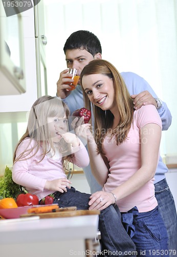 Image of happy young family in kitchen