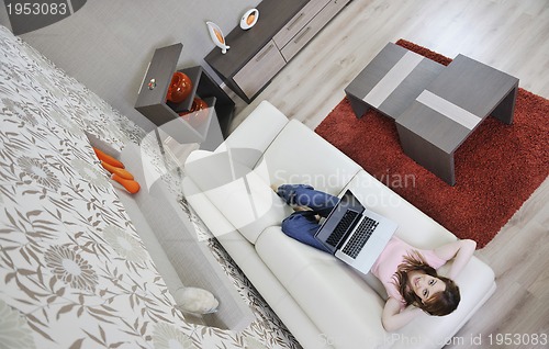 Image of woman relaxing and working at home