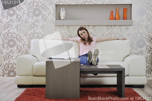 Image of woman relaxing and working at home 