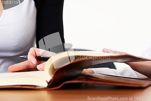 Image of Woman writing in organizer