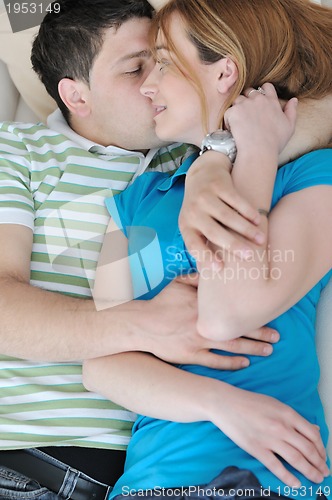 Image of couple relax at home on sofa in living room