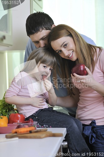 Image of happy young family in kitchen