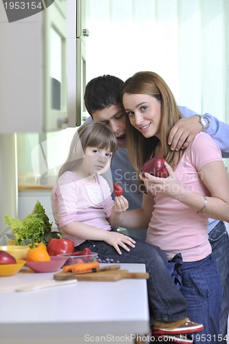 Image of happy young family in kitchen