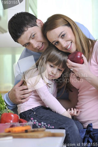 Image of happy young family in kitchen