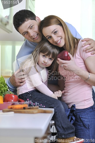 Image of happy young family in kitchen