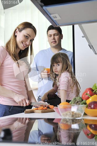 Image of happy young family in kitchen