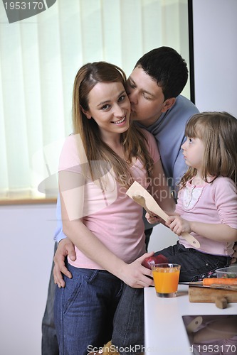 Image of happy young family in kitchen