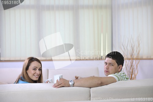 Image of couple relax at home on sofa in living room