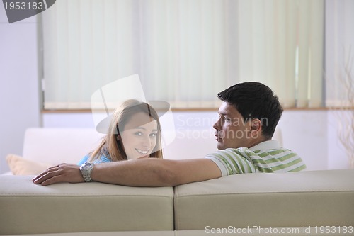 Image of couple relax at home on sofa in living room