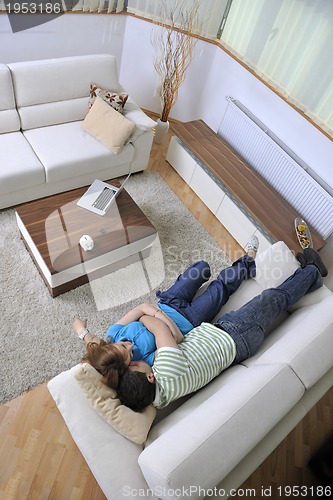 Image of couple relax at home on sofa in living room