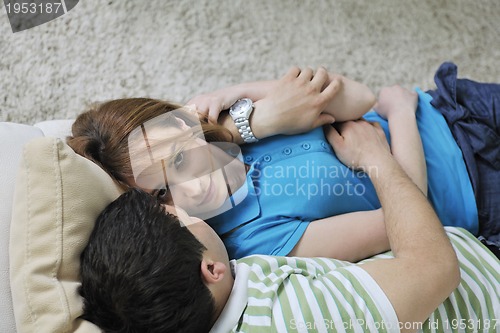 Image of couple relax at home on sofa in living room