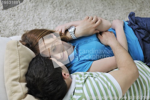 Image of couple relax at home on sofa in living room
