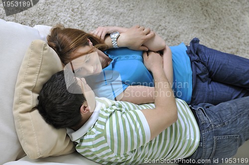 Image of couple relax at home on sofa in living room