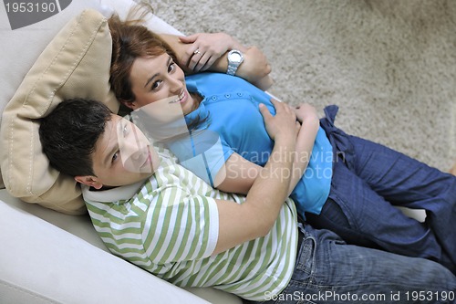 Image of couple relax at home on sofa in living room