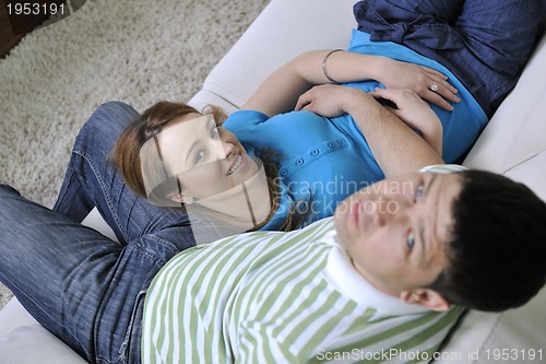Image of couple relax at home on sofa in living room