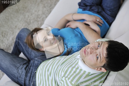 Image of couple relax at home on sofa in living room